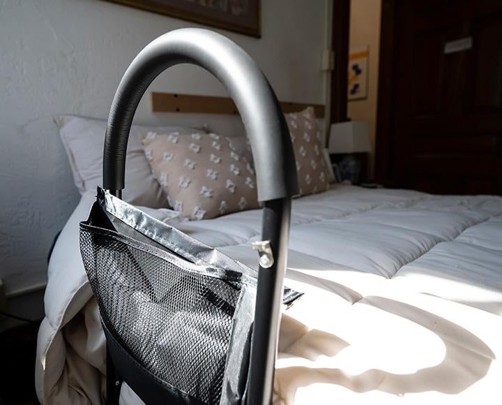 An assistive device on the side of a bed