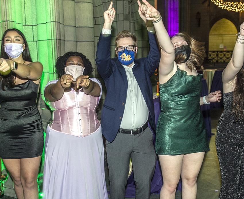 Students raising hands at the Cathedral Ball