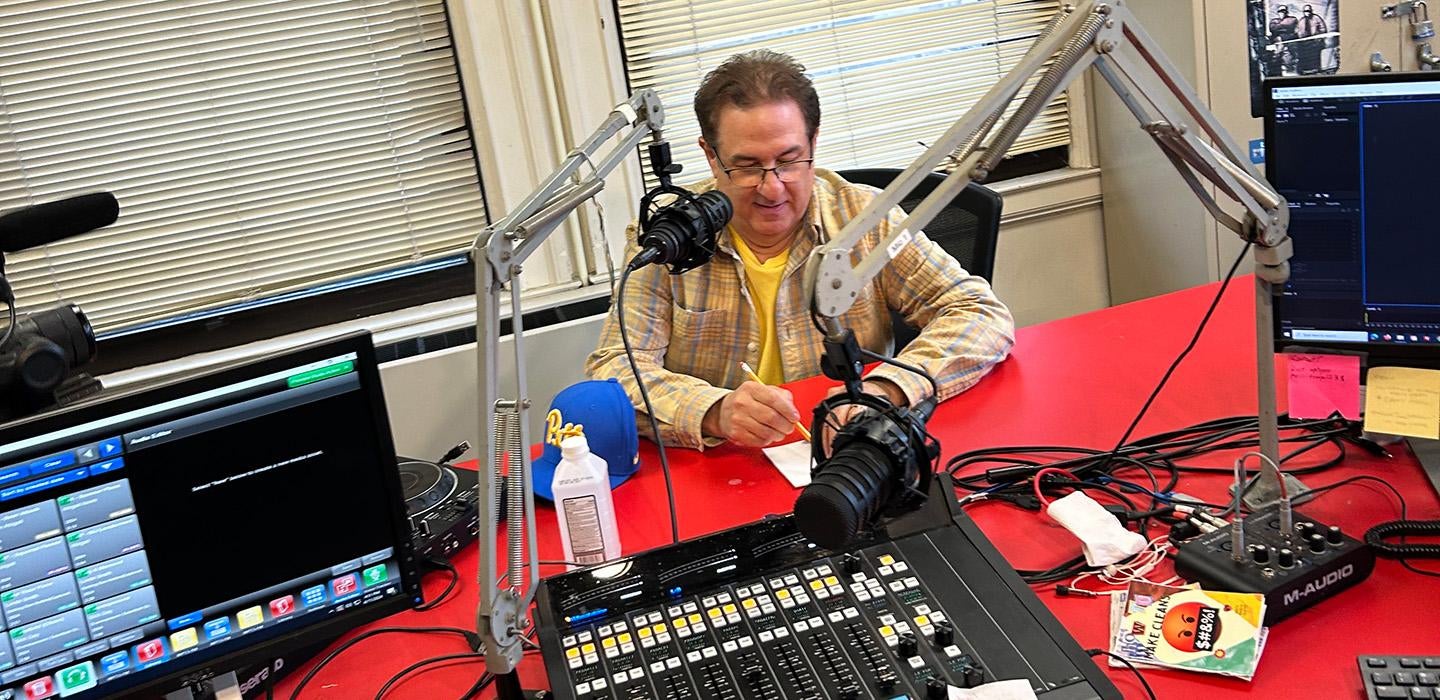 Bergman sits at a microphone in the WPTS studio