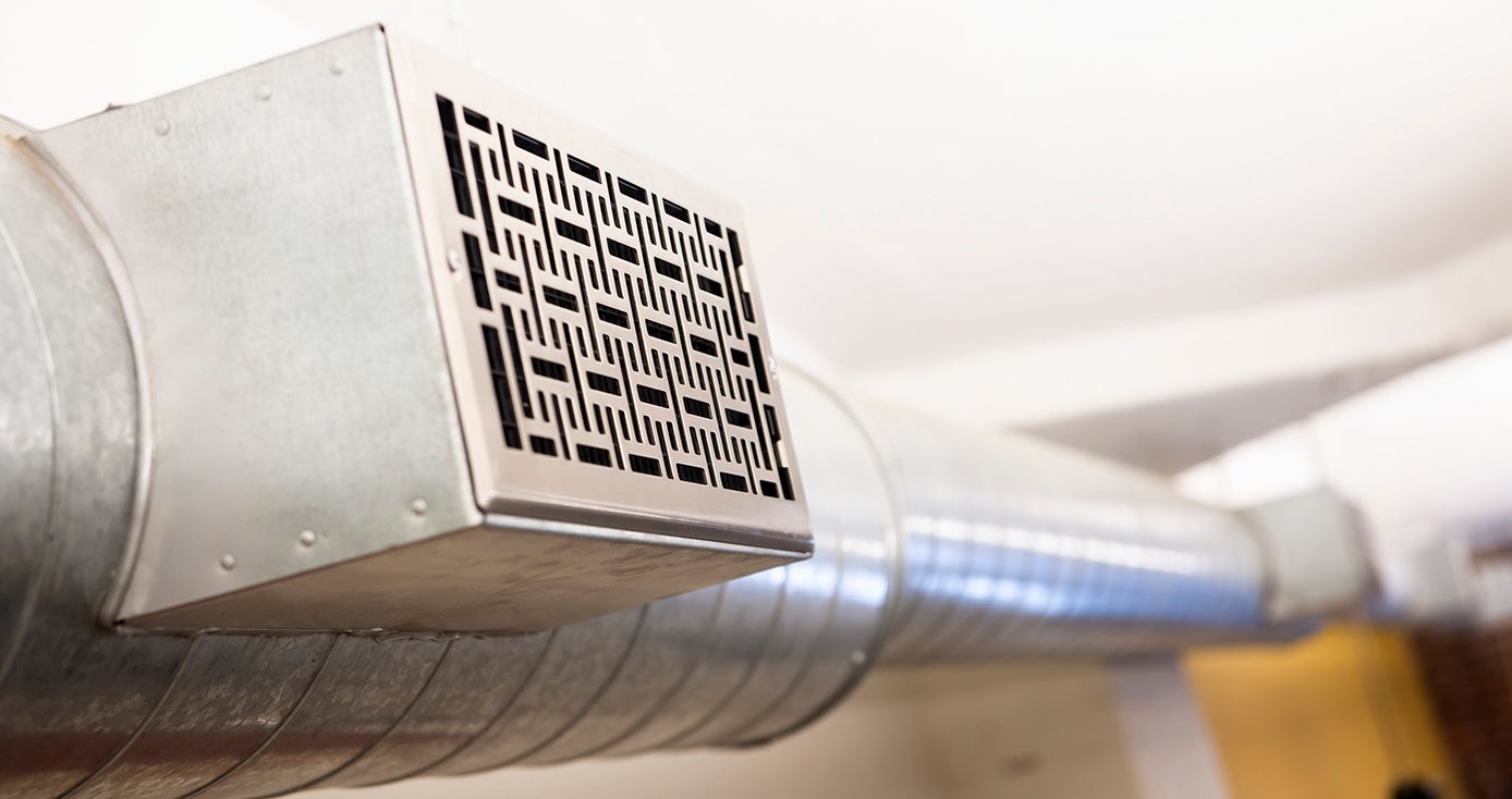 a silver air duct with a fancy-designed grate over top of the output spot