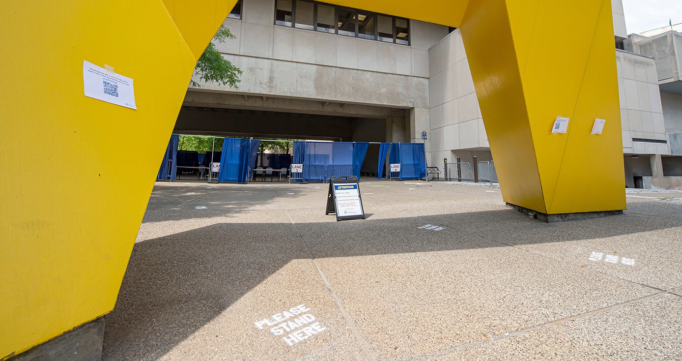 A sign underneath a large yellow sculpture