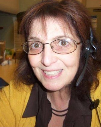 Haberman wearing a headset and yellow blouse
