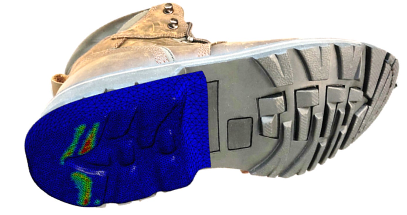 the underside of a work boot—the heel is blue, green and red to show the modeling, while the toe portion is gray and a typical looking tread