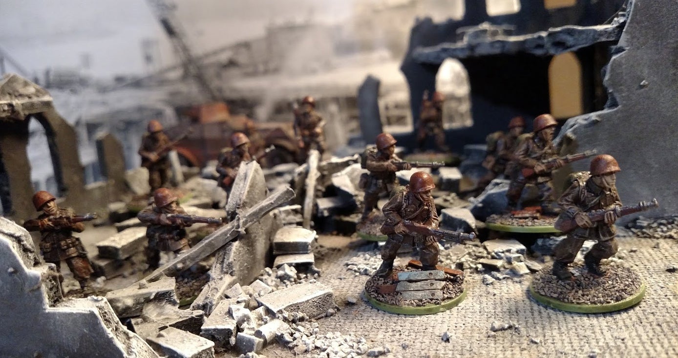 Miniature figures of soldiers in a tabletop scene.