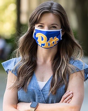 a woman in a blue and gold face covering