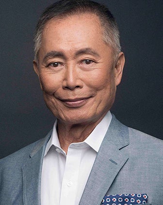 Takei in a gray suit