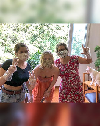 Keila Grinberg and her daughters in face masks