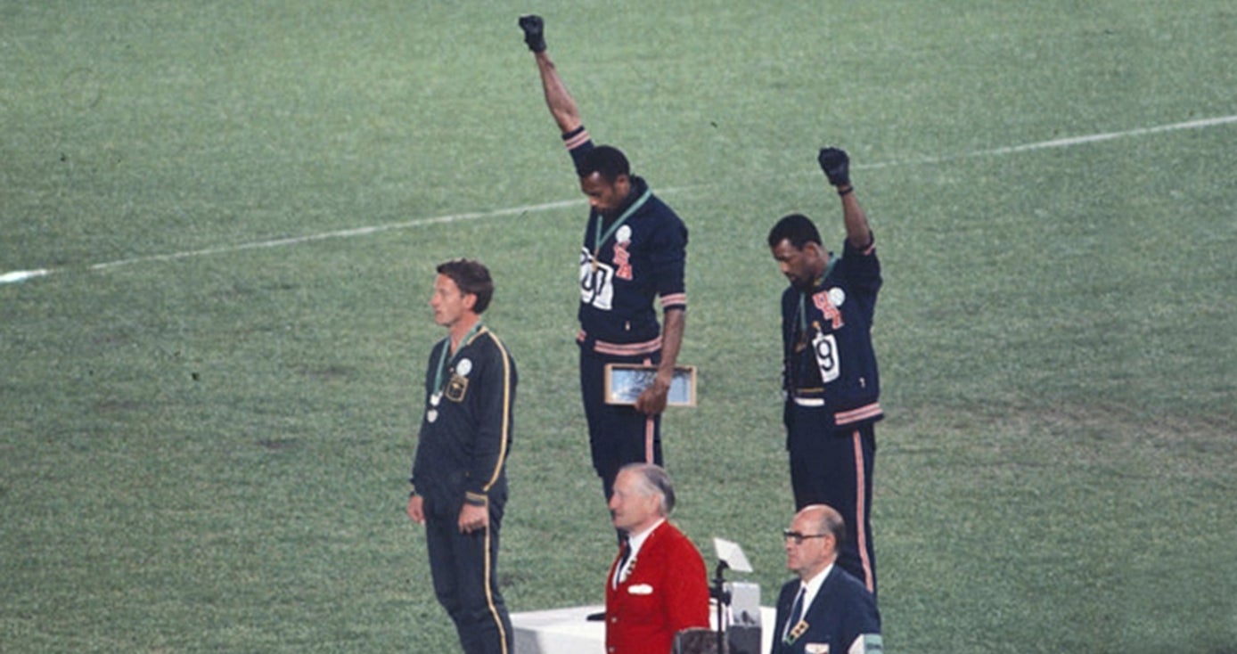 Tommy Smith and John Carlos on a podium holding their fists in the air