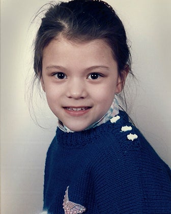 Libertus as a child, wearing a navy blue sweater