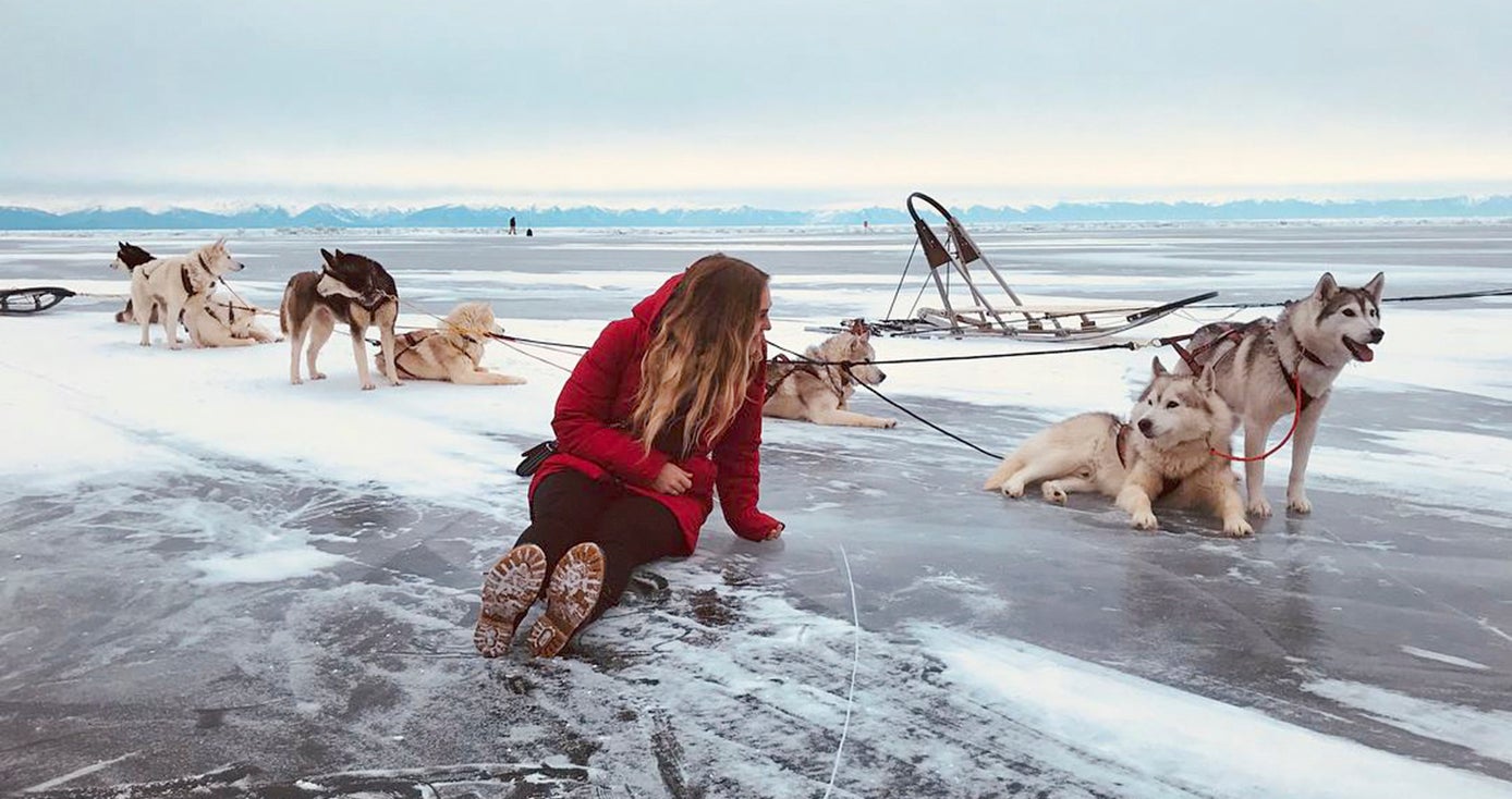 Marjorie Tolsdorf with a group of sled dogs in Russia
