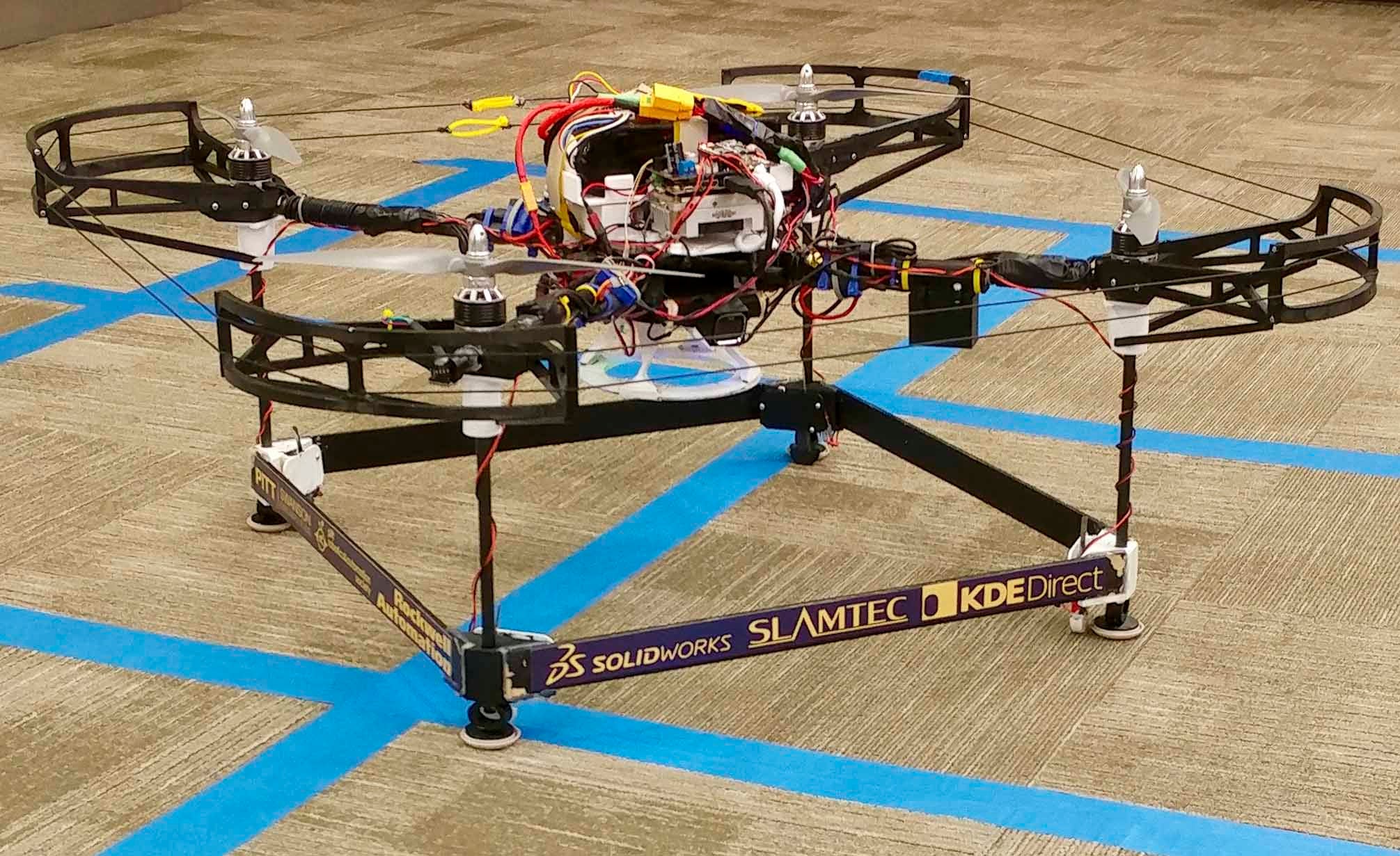 the drone, on a brown and blue carpet