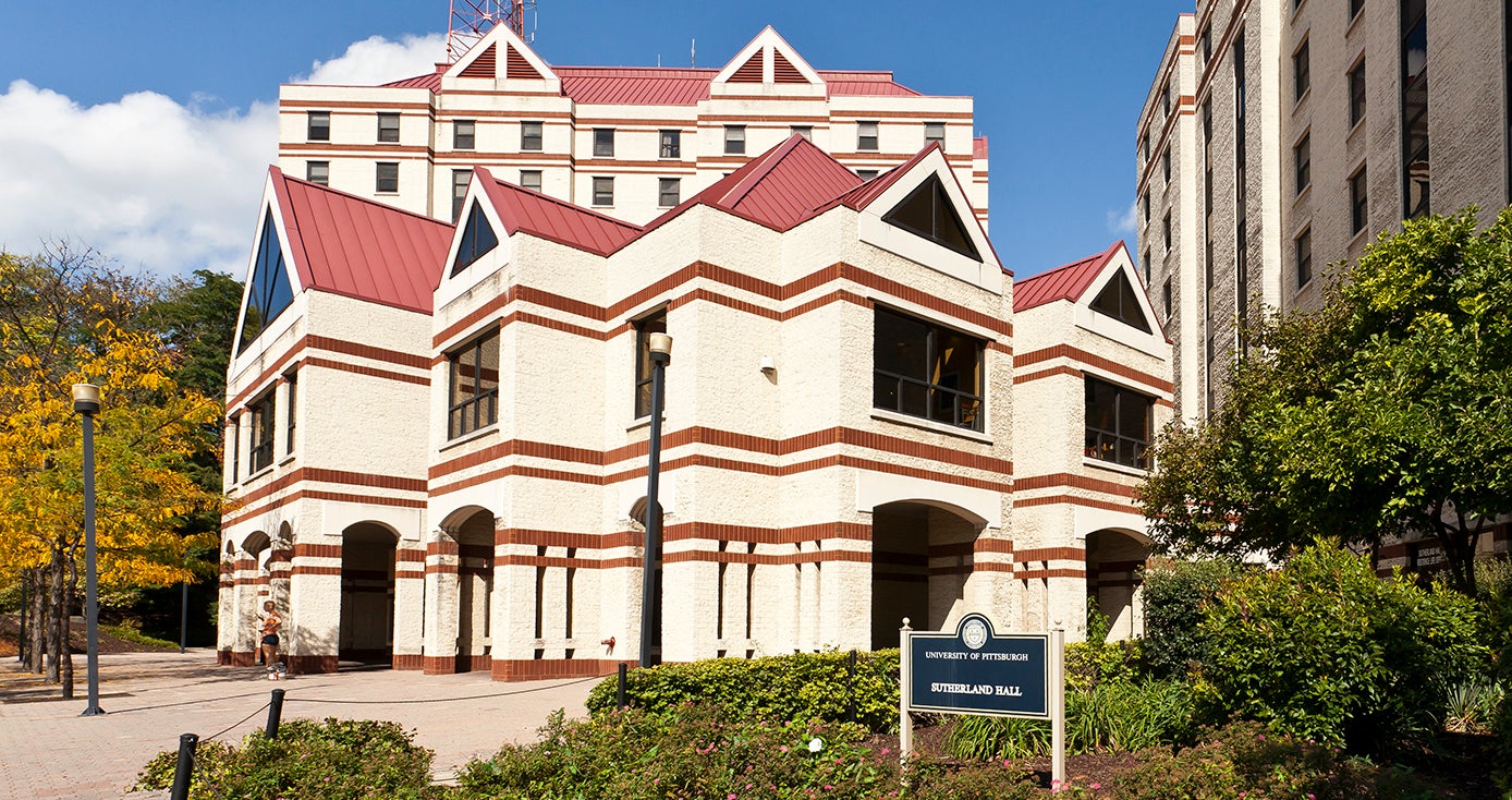 photo of Sutherland Hall, a white and maroon building in upper campus