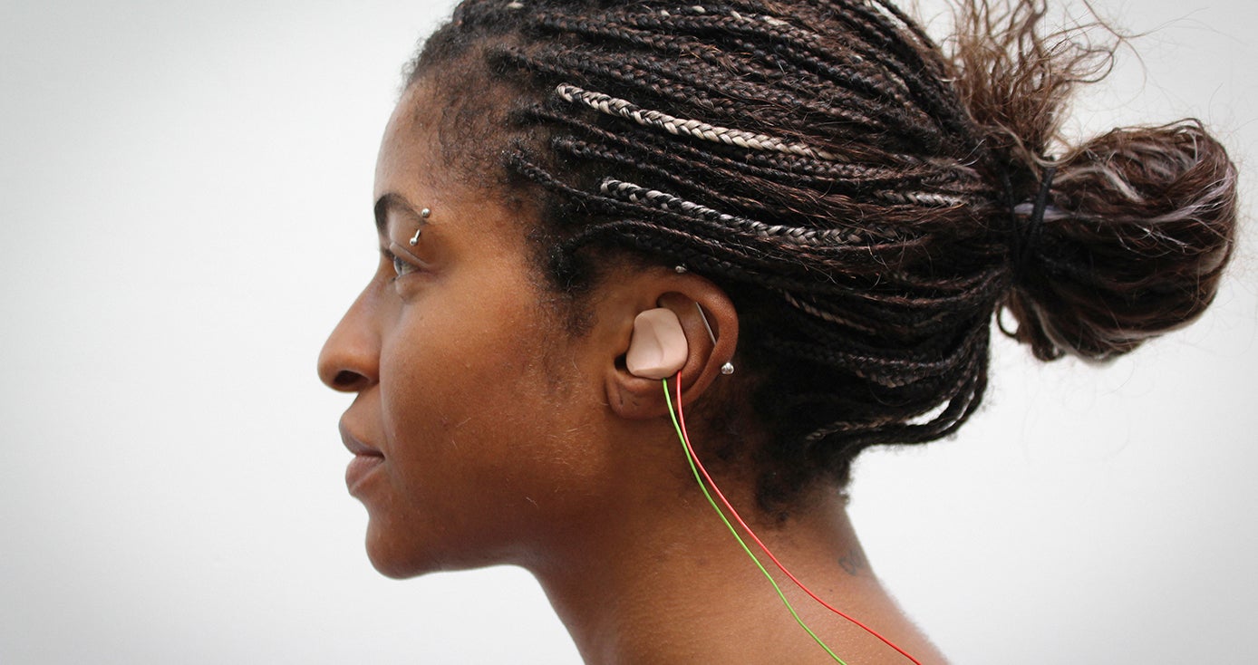 A earbud in a woman's left ear