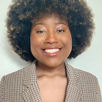 a young woman in a brown blazer