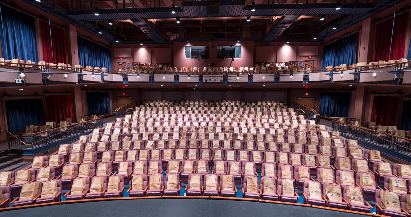 Empty theater with paper bags in each of its 500 seats