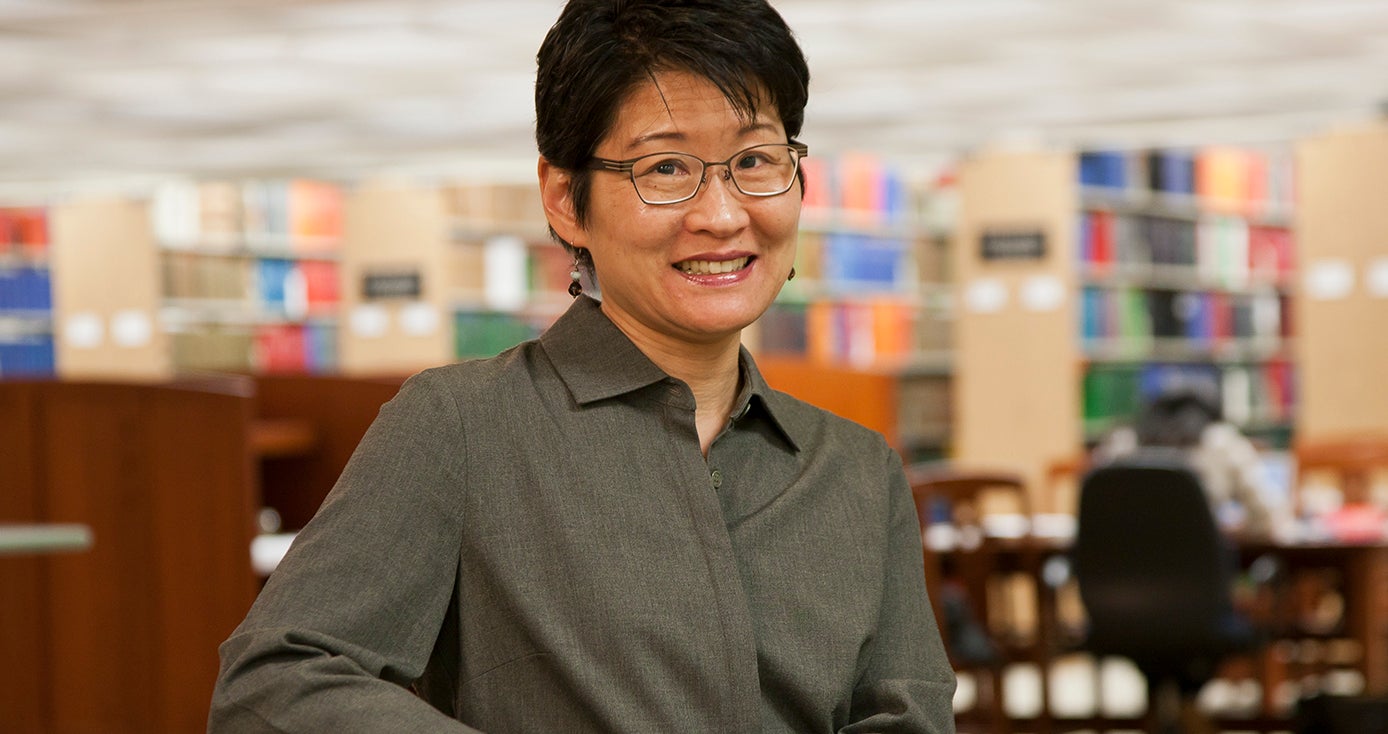 Lu-in Wang in a gray shirt in a library