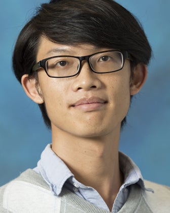 Wei Peng in glasses and a light shirt against a light blue background