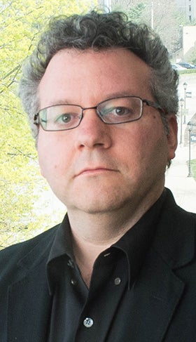 Seth M. Weinberg in a black dress shirt outdoors