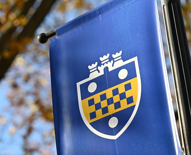 A blue flag with a Pitt shield
