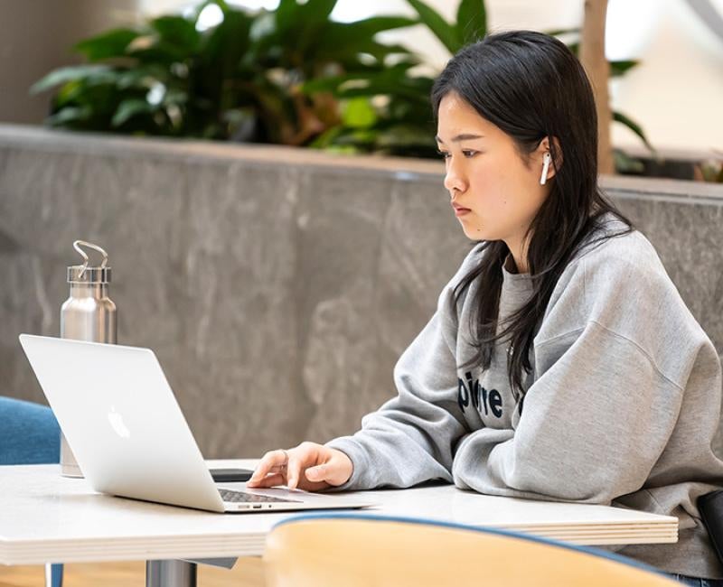 A student works on a Macbook