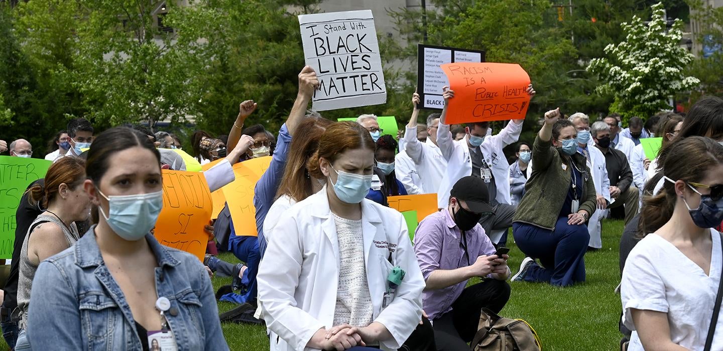 People in white lab coats protest for Black Lives Matter