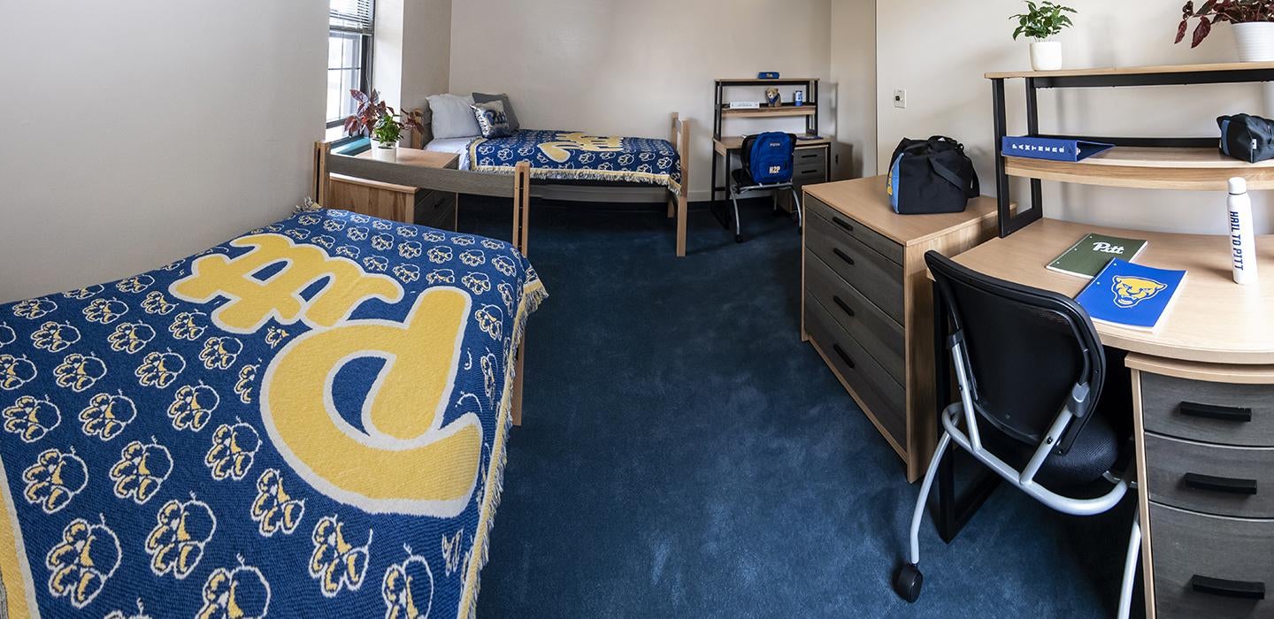 Pitt dorm room with two desks and two beds