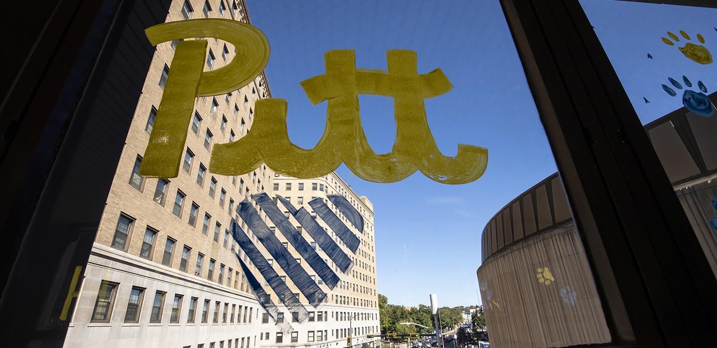 Window art of Pitt in gold text with a blue heart