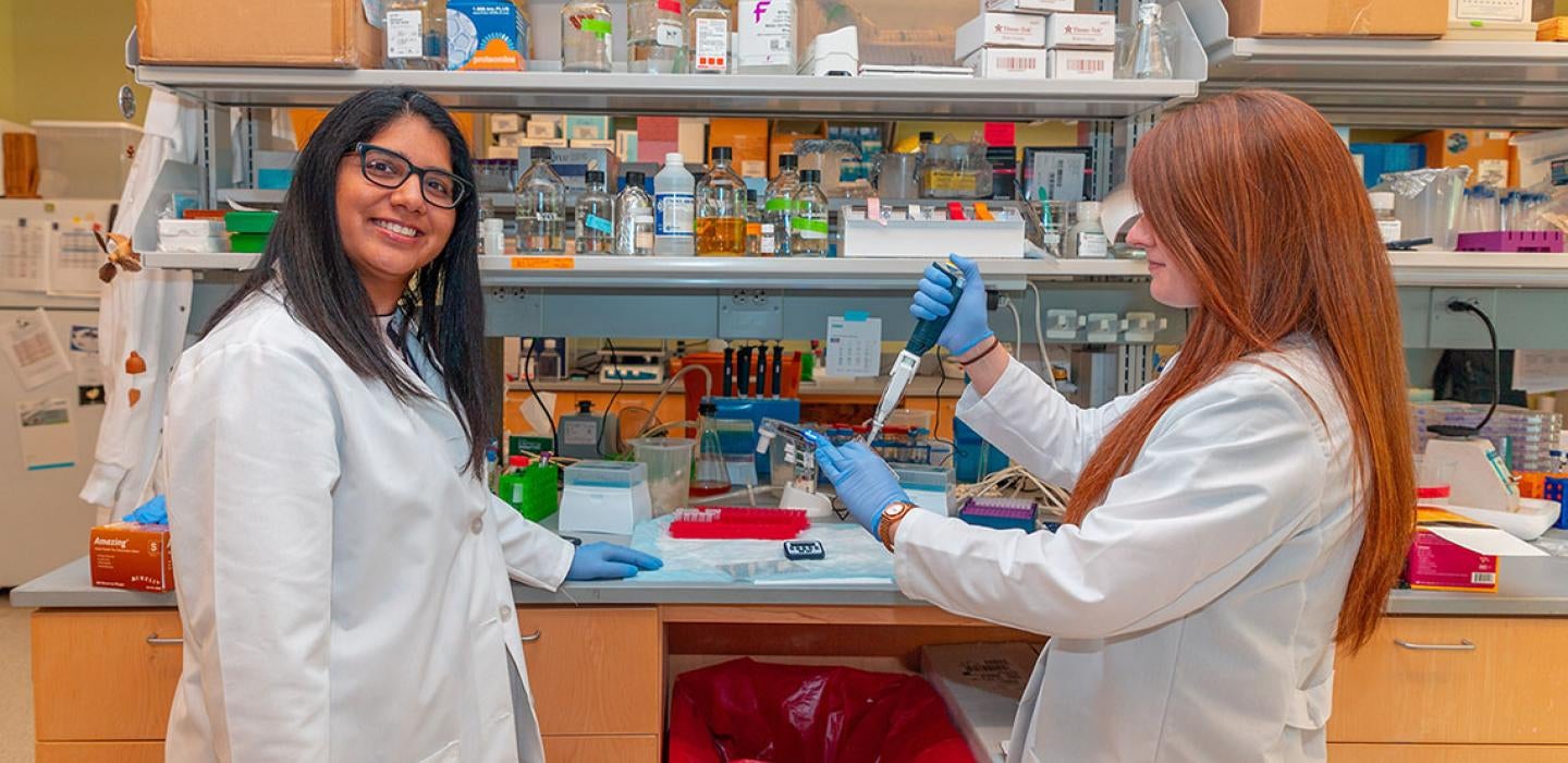 Seema Lakdawala in lab coat 