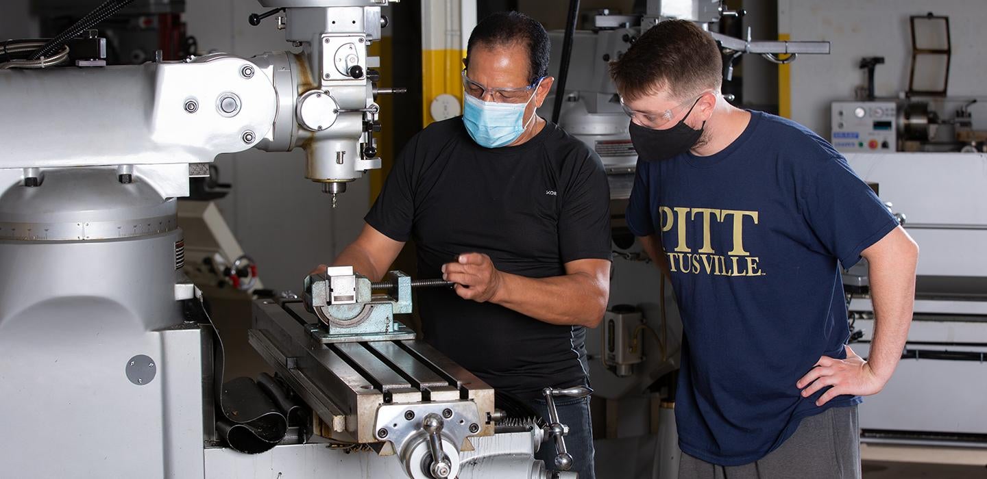 Pitt-Titusville machinists working with machine