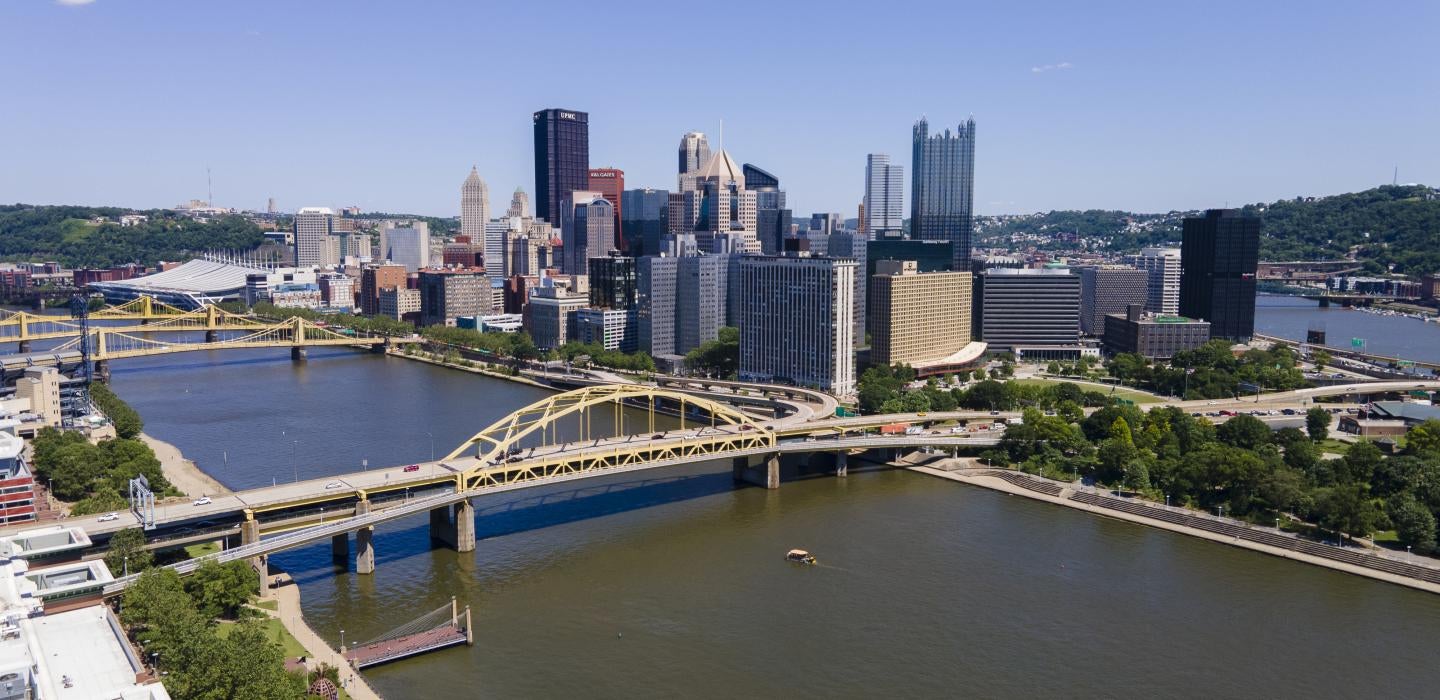 Pittsburgh skyline in the daytime with view of yellow bridges and rivers