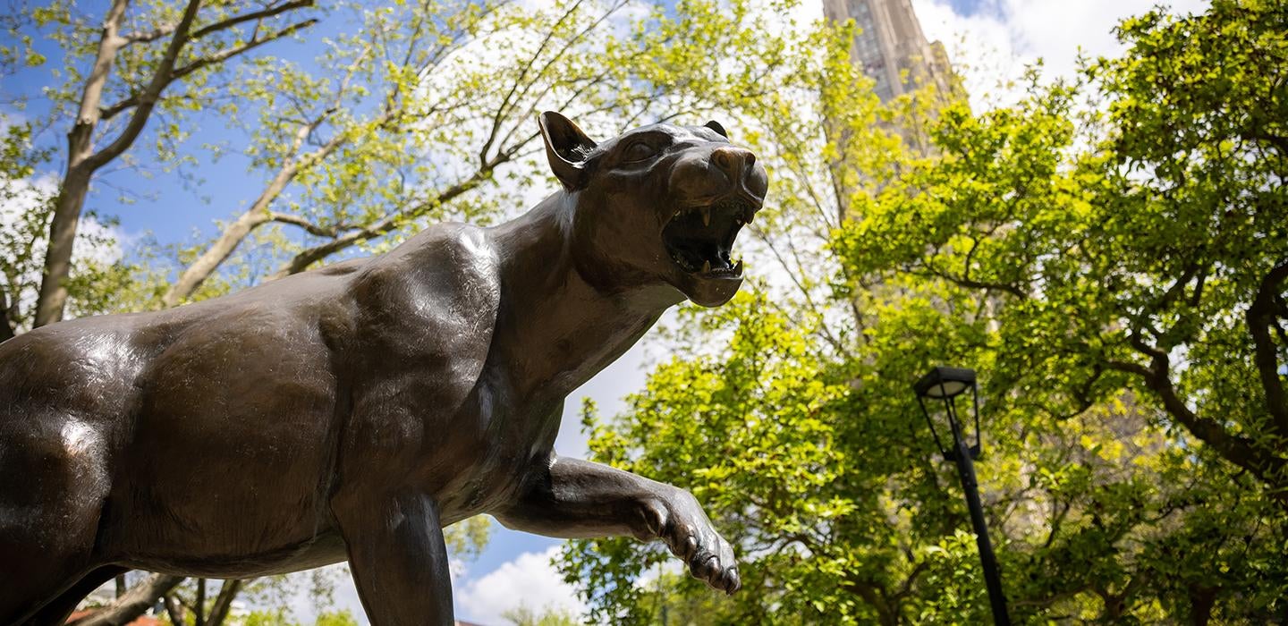 Panther statue in front of the Cathedral of Learning on a sunny day