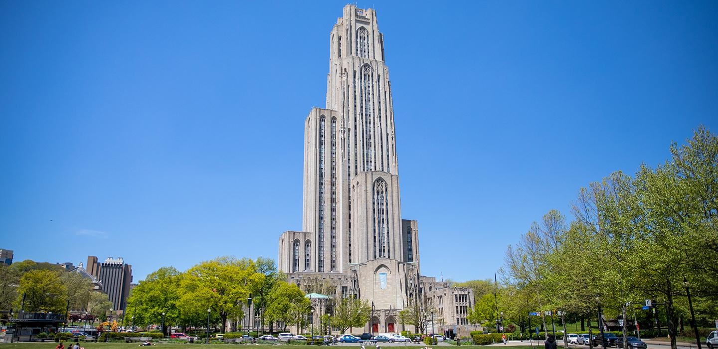 The Cathedral of Learning with surrounding trees during the daytime