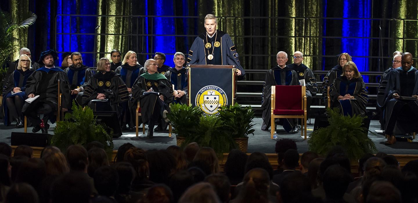 Chancellor Patrick Gallagher speaking at podium during ceremony