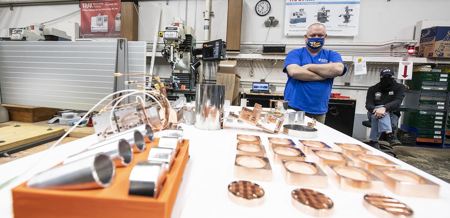 Man wearing Pitt mask standing in machine shop