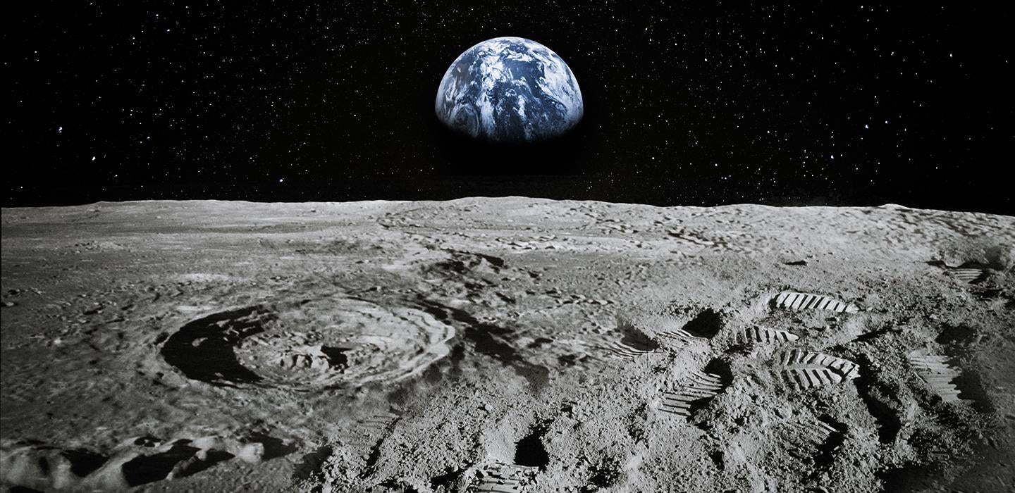 The moon's surface with the Earth in the background