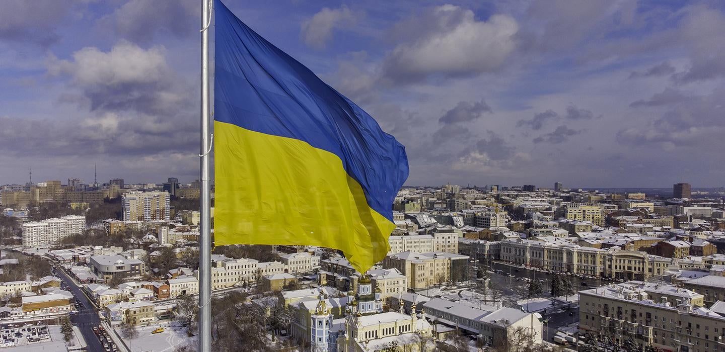 a Ukrainian flag over a city
