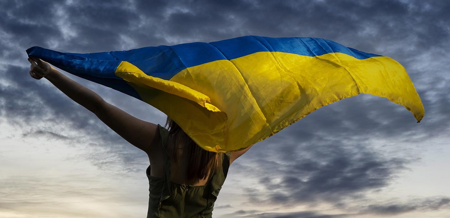 Woman holding Ukraine flag 