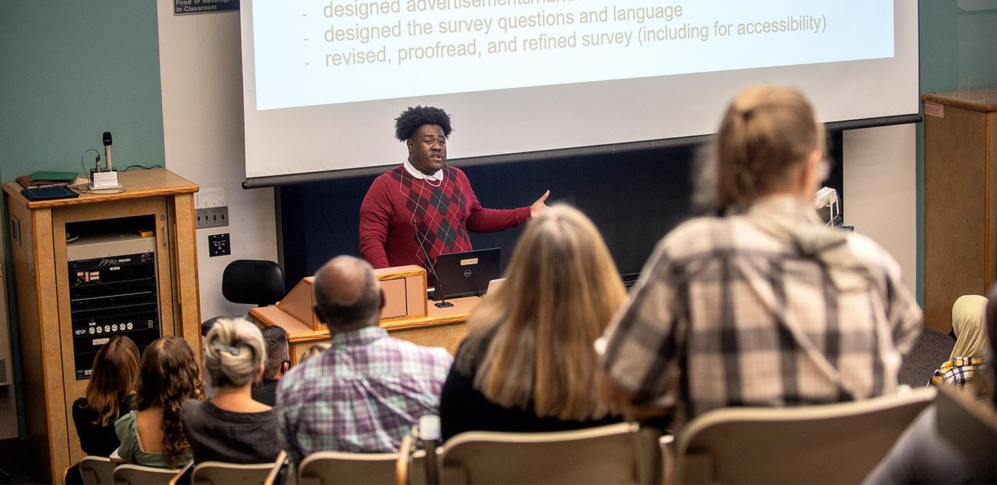 a student presenting to a group of people