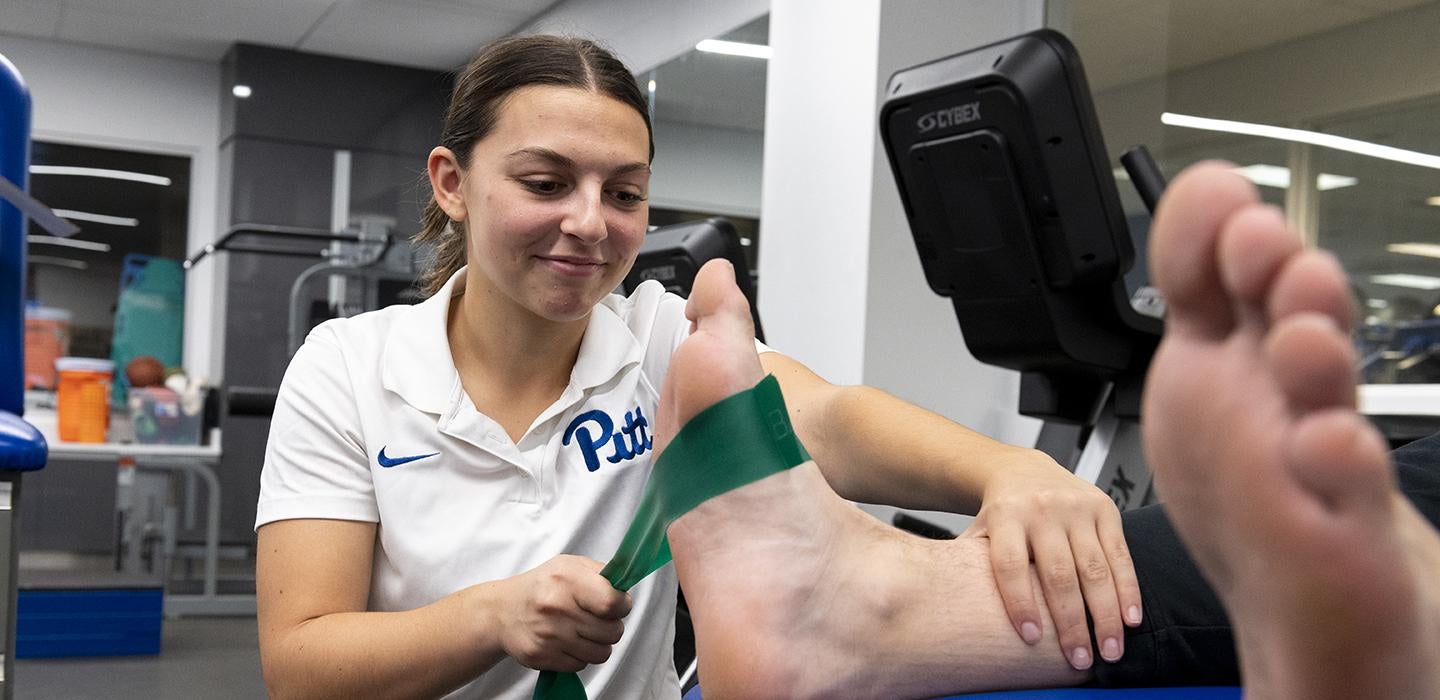 Jessica Muney treats a Pitt football player