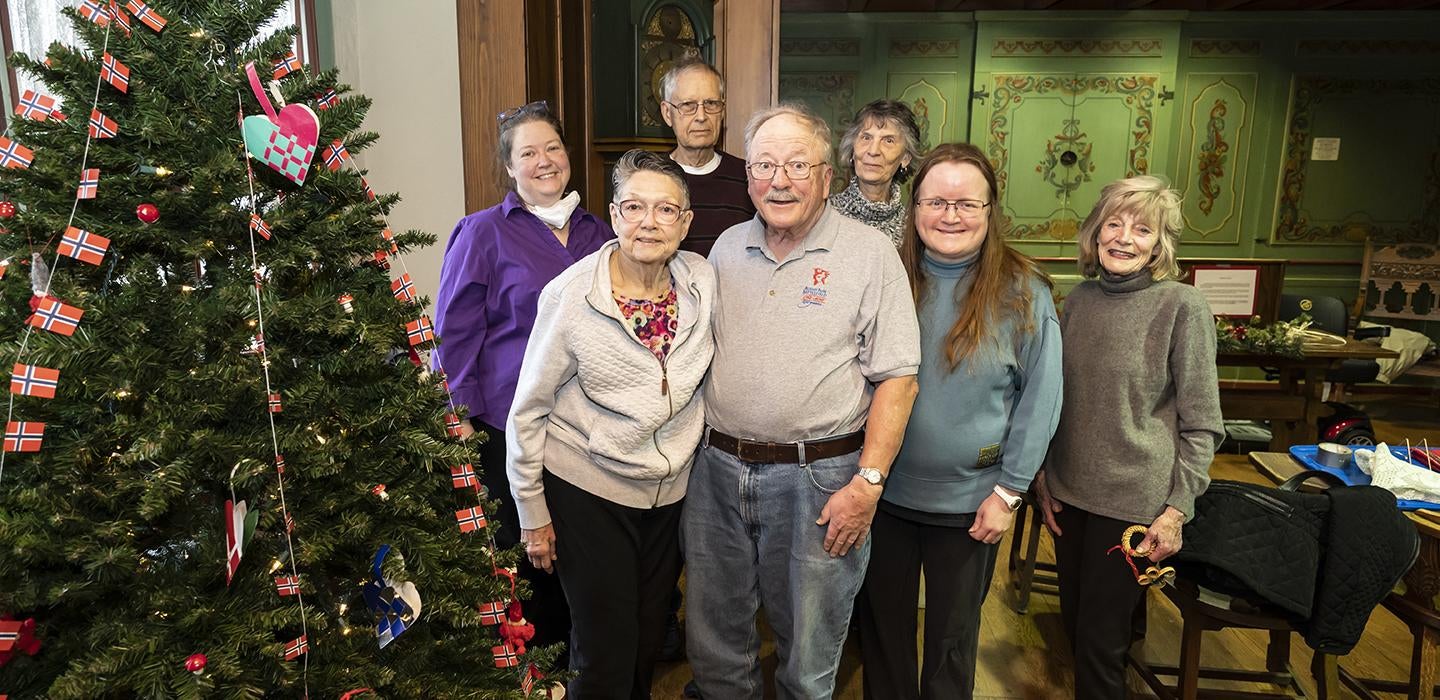 a family standing next to a Christmas tree