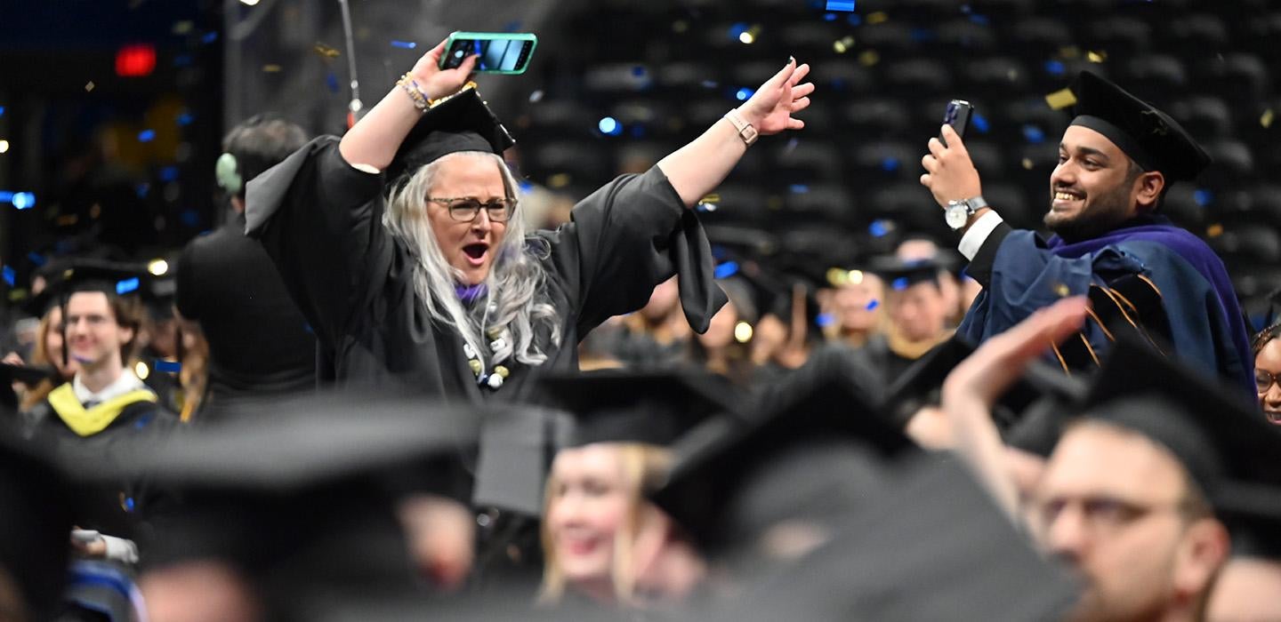 Graduates dance in celebration as confetti falls