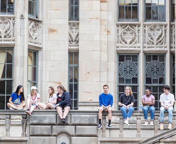 Students sitting on ledge