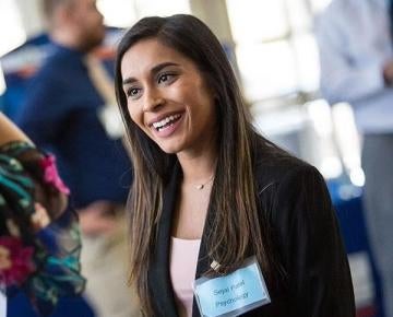 Woman smiling wearing nametag