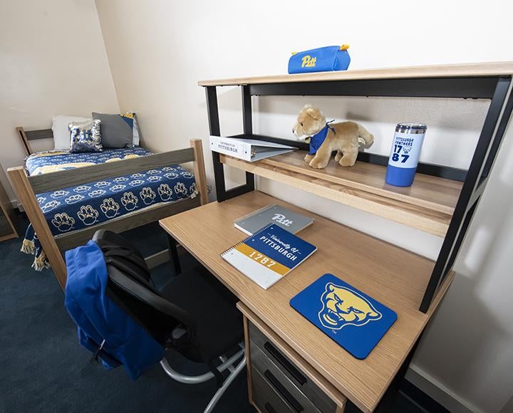 Dorm desk decorated with Pitt emblemed items
