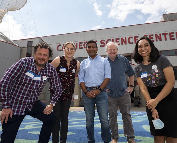 Scientists smiling outside of the Carnegie Science Center