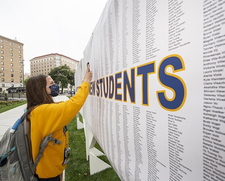 Pitt student in yellow sweater finds her name on new student list