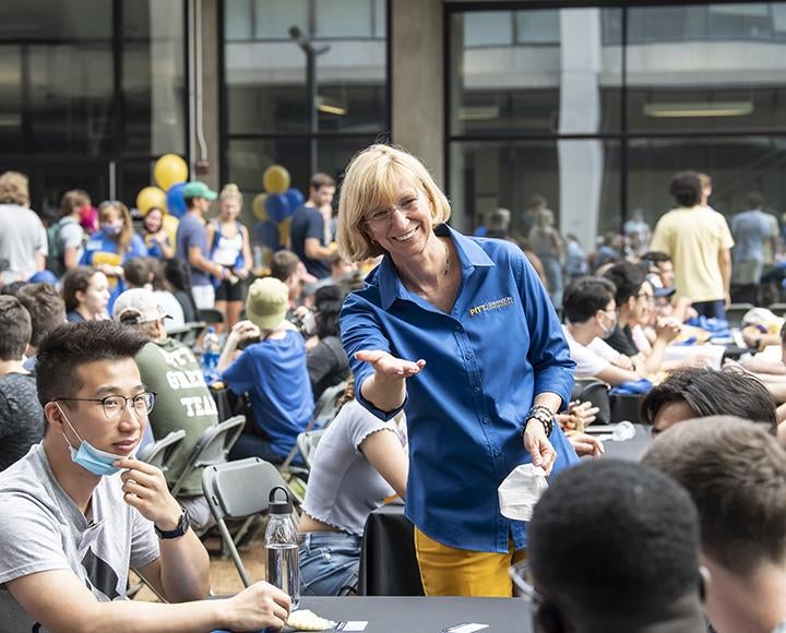 Mary Besterfield-Sacre welcomes students throughout the Benedum Hall courtyard 
