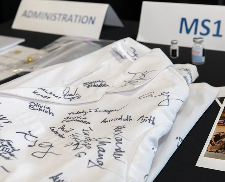 A lab coat signed with the names of first-year medical students.