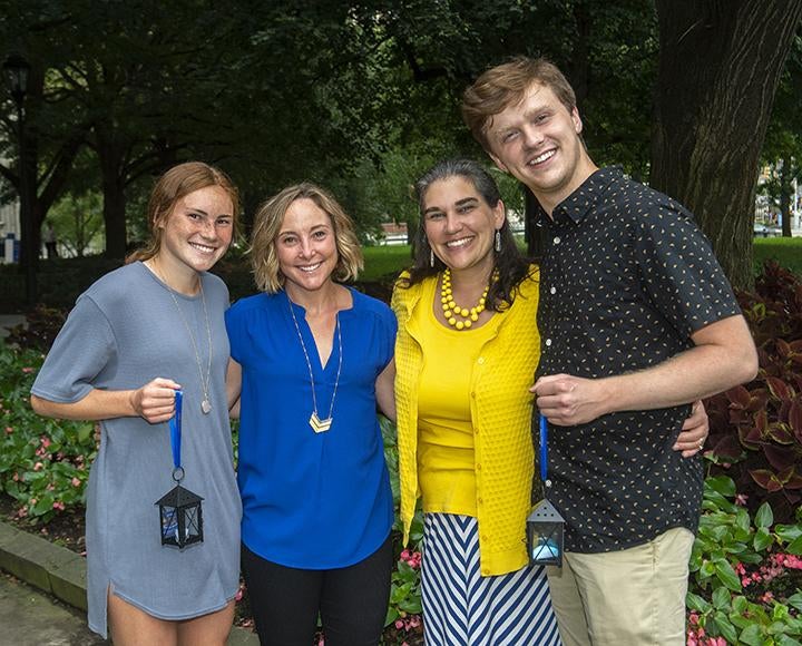 First-year student Ellie Coffield, far left, and her cousin, sophomore Isaac Anticole, far right, attended this year’s Lantern Night with their flame bearer mothers, Kelly Coffield and Erin Anticole 