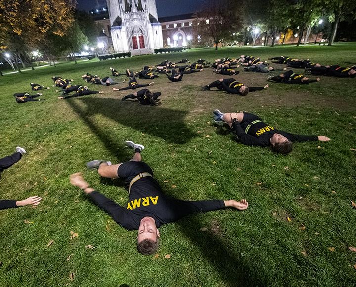 ROTC Army members gathered on the lawn of the Cathedral of Learning for physical training